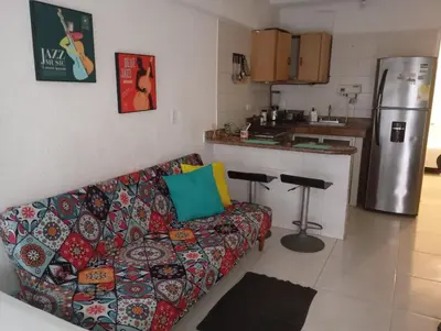 a living room with a couch and a kitchen at @casa__grace Apartaestudio en edificio al frente del mar!! in Cartagena de Indias
