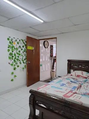 a bedroom with a bed and a clock on the wall at Hostal Casa Lara in Cartagena de Indias