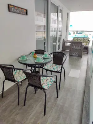 a table and chairs in a room with a table at Apartamento morros con acceso directo a la playa in Cartagena de Indias