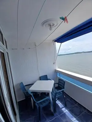 a table and chairs in the back of a boat at Apartamento con hermosa vista al mar en cartagena de indias in Cartagena de Indias