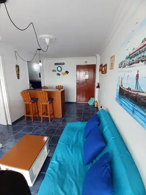 a living room with a blue couch and a table at Apartamento con hermosa vista al mar en cartagena de indias in Cartagena de Indias