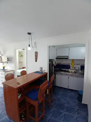 a kitchen with a wooden table and chairs at Apartamento con hermosa vista al mar en cartagena de indias in Cartagena de Indias