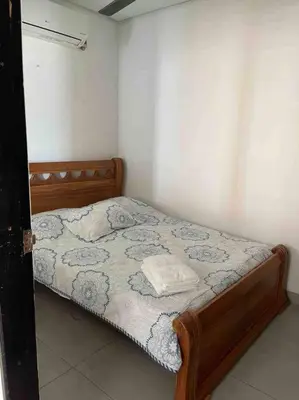 a bedroom with a bed with a wooden frame at Apartamento en Coveñas cerca al mar #204 in Coveñas