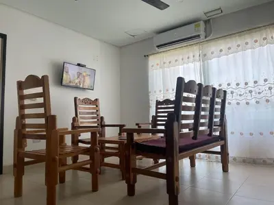 a dining room with wooden chairs and a table at Apartamento en Coveñas cerca al mar #204 in Coveñas