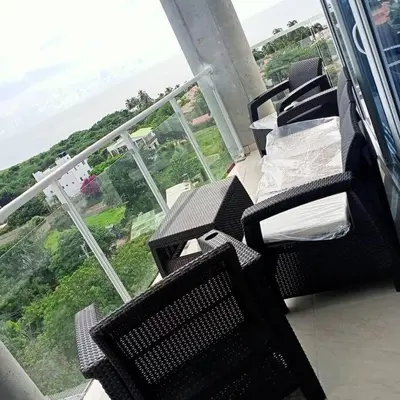 a balcony with two chairs and a view of the ocean at Apto Vista Mar 2 cuadras Playa, Jaccuzi BBQ Wifi Parqueadero y Ascensor 7 Piso in Santa Marta