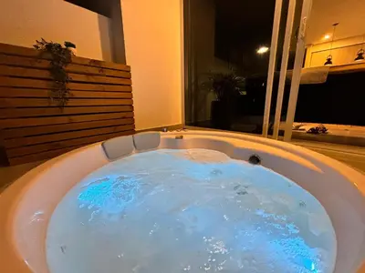 a jacuzzi tub with blue water in a room at Dominiqueplayaazul apto de lujo con Jacuzzi privado en balcon in Cartagena de Indias