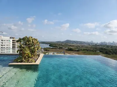 a swimming pool with a view of a city at Dominiqueplayaazul apto de lujo con Jacuzzi privado en balcon in Cartagena de Indias