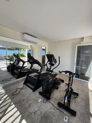 a gym with several exercise bikes in a room at Dominiqueplayaazul apto de lujo con Jacuzzi privado en balcon in Cartagena de Indias