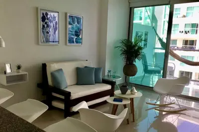 a living room with a couch and a table and chairs at Cartagena- Apto con acceso y vista al mar Morros Ultra in Cartagena de Indias