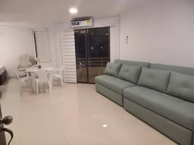 a living room with a couch and a table at Vista a la Playa del Cabrero in Cartagena de Indias