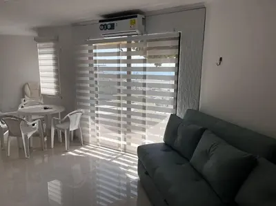 a living room with a couch and a table at Vista a la Playa del Cabrero in Cartagena de Indias