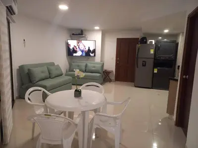 a living room with a table and a couch at Vista a la Playa del Cabrero in Cartagena de Indias