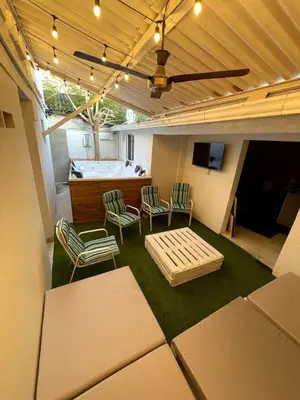 a room with a room with a tub and chairs at Wonderful trinity beach house in crespo. in Cartagena de Indias