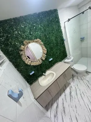 a bathroom with a mirror and a sink and a toilet at Wonderful trinity beach house in crespo. in Cartagena de Indias