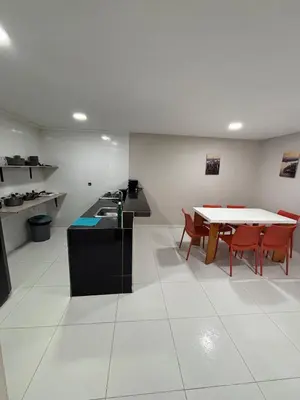 a kitchen with a table and some chairs and a table at Wonderful trinity beach house in crespo. in Cartagena de Indias