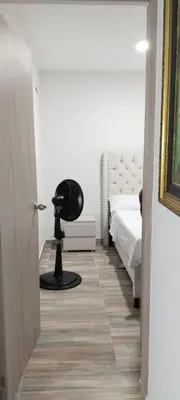 a bedroom with a black chair in the middle of a room at Brisa de la Bahia in Cartagena de Indias