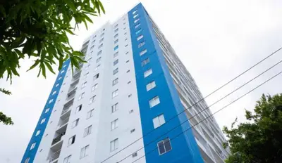 a tall blue and white building with trees in front of it at Brisa de la Bahia in Cartagena de Indias