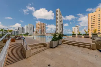 a building with a swimming pool and a city at amor por cartagena in Cartagena de Indias