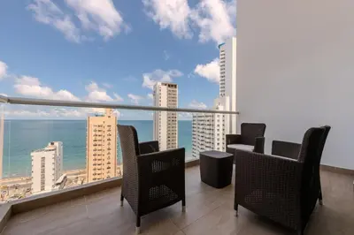 a balcony with chairs and a view of the ocean at amor por cartagena in Cartagena de Indias