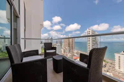 a balcony with chairs and a view of the ocean at amor por cartagena in Cartagena de Indias
