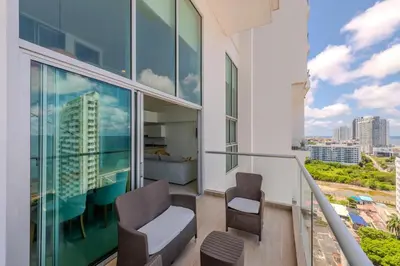 a balcony with two chairs and a view of a city at amor por cartagena in Cartagena de Indias