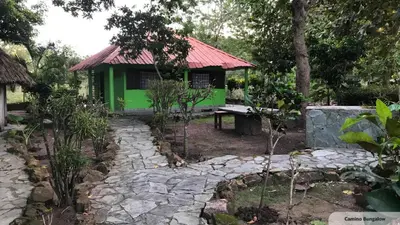 a green house with a stone path in front of it at Casa Santa María in El Porvenir