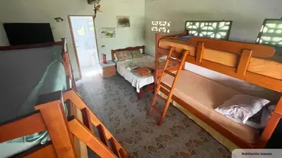 a room with two bunk beds and a tv at Casa Santa María in El Porvenir