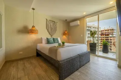 a bedroom with a bed and a large window at DQ1102 Hermoso con Jacuzzi priv y Vista increíble - 10 min Centro Historico in Cartagena de Indias