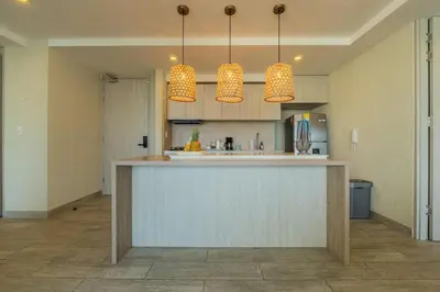 a kitchen with a counter and two pendant lights at DQ1102 Hermoso con Jacuzzi priv y Vista increíble - 10 min Centro Historico in Cartagena de Indias