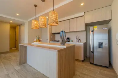 a kitchen with a counter and a refrigerator at DQ1102 Hermoso con Jacuzzi priv y Vista increíble - 10 min Centro Historico in Cartagena de Indias