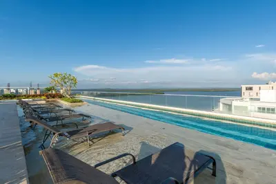a swimming pool with lounge chairs and the water at MQ701 Nuevo Apto Boho Style Jacuzzi privado in Cartagena de Indias