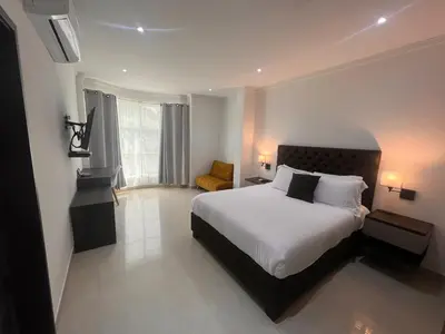 a hotel room with a bed and a chair at Hotel Zuriel Boutique in Cartagena de Indias