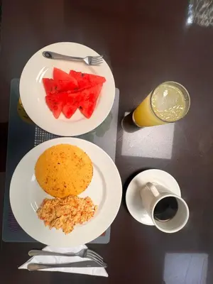 a table with plates of food and a cup of coffee at Hotel Zuriel Boutique in Cartagena de Indias