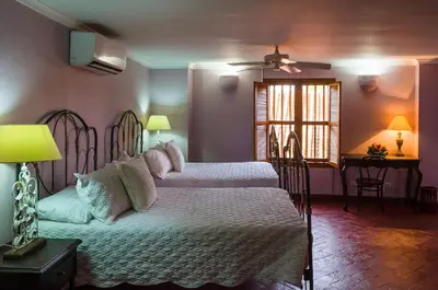 a bedroom with two beds and a window at Hotel Boutique Casa Córdoba Estrella in Cartagena de Indias