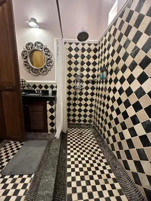 a bathroom with a shower with black and white checkered tiles at Hotel Boutique Casa Córdoba Estrella in Cartagena de Indias