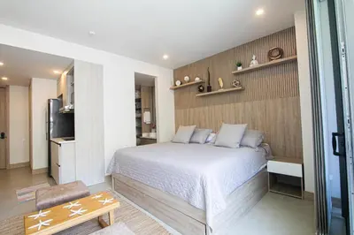 a bedroom with a bed and a television in it at Apartamento en Condominio con acceso directo al mar en Cartagena in Cartagena de Indias