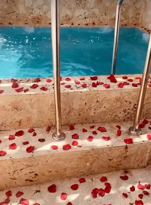 a set of three steps with red flowers on them at Casa Acogedora con Piscina - House Rouse 14 in Cartagena de Indias