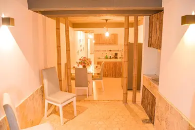 a kitchen and dining room with a table and chairs at Casa Acogedora con Piscina - House Rouse 14 in Cartagena de Indias