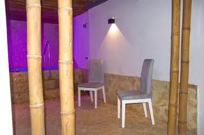 two chairs in a room with bamboo poles at Casa Acogedora con Piscina - House Rouse 14 in Cartagena de Indias