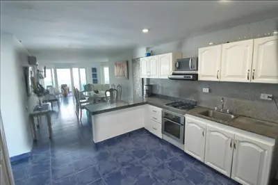 a kitchen with white cabinets and a counter top at Apartamento de 3 habitaciones, 1103 in Cartagena de Indias
