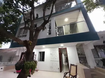 a house with a tree in front of it at Apartaestudio Cartagena 4P in Cartagena de Indias