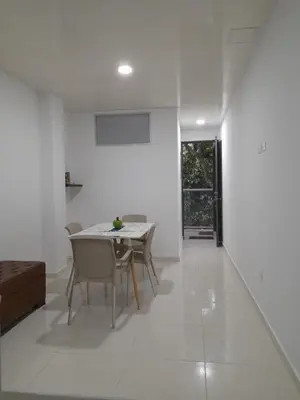 a white living room with a table and chairs at Apartaestudio Cartagena 4P in Cartagena de Indias