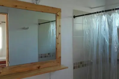 a mirror in a bathroom with a shower at Cabaña 2 en la mejor playa de Coveñas in Coveñas