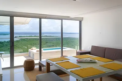 a living room with a table and a large window at 2 dormitorios Morros. Hidromasaje y Vistas in Cartagena de Indias