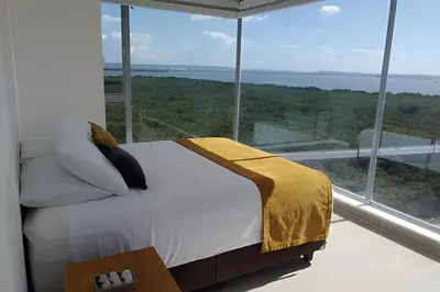 a bedroom with a bed and a large window at 2 dormitorios Morros. Hidromasaje y Vistas in Cartagena de Indias