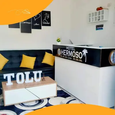 a living room with a couch and a table at HOTEL HERMOSO CARIBE in Tolú