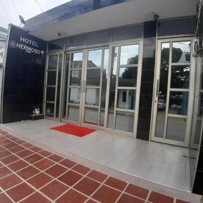 a hotel entrance with a red mat in front of it at HOTEL HERMOSO CARIBE in Tolú