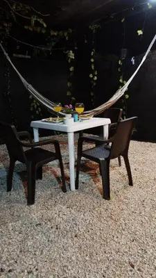 a white table with two chairs and two wine glasses at HOTEL HERMOSO CARIBE in Tolú
