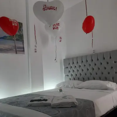 a bedroom with red balloons and a bed with a heart balloon at HOTEL HERMOSO CARIBE in Tolú