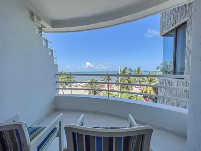 a balcony with a table and chairs and a view of the ocean at Cartagena beach front in Cartagena de Indias